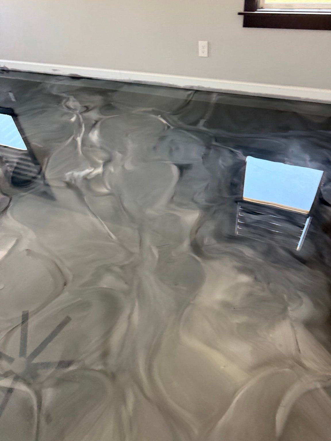 Close view of the gray, cream and charcoal movement in a finished Resinart Finishes floor