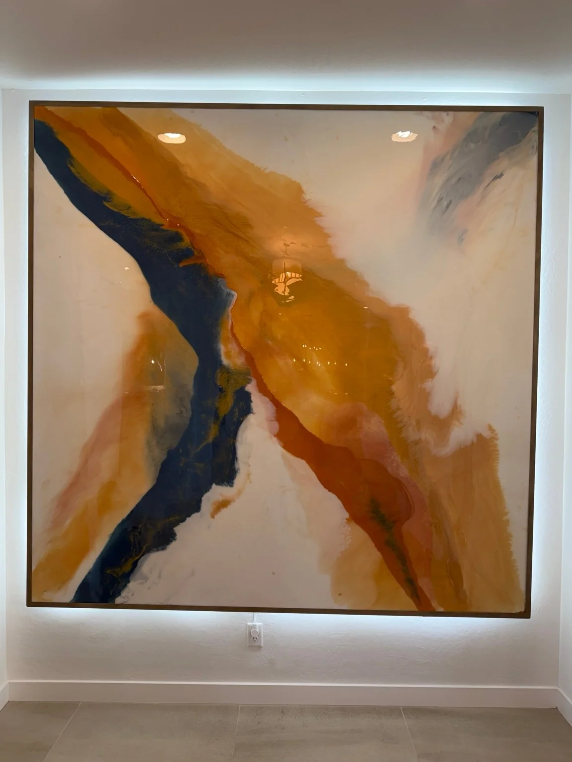 Actual Resinart Finishes backlit wall installation with gold, terracotta, navy and cream movement